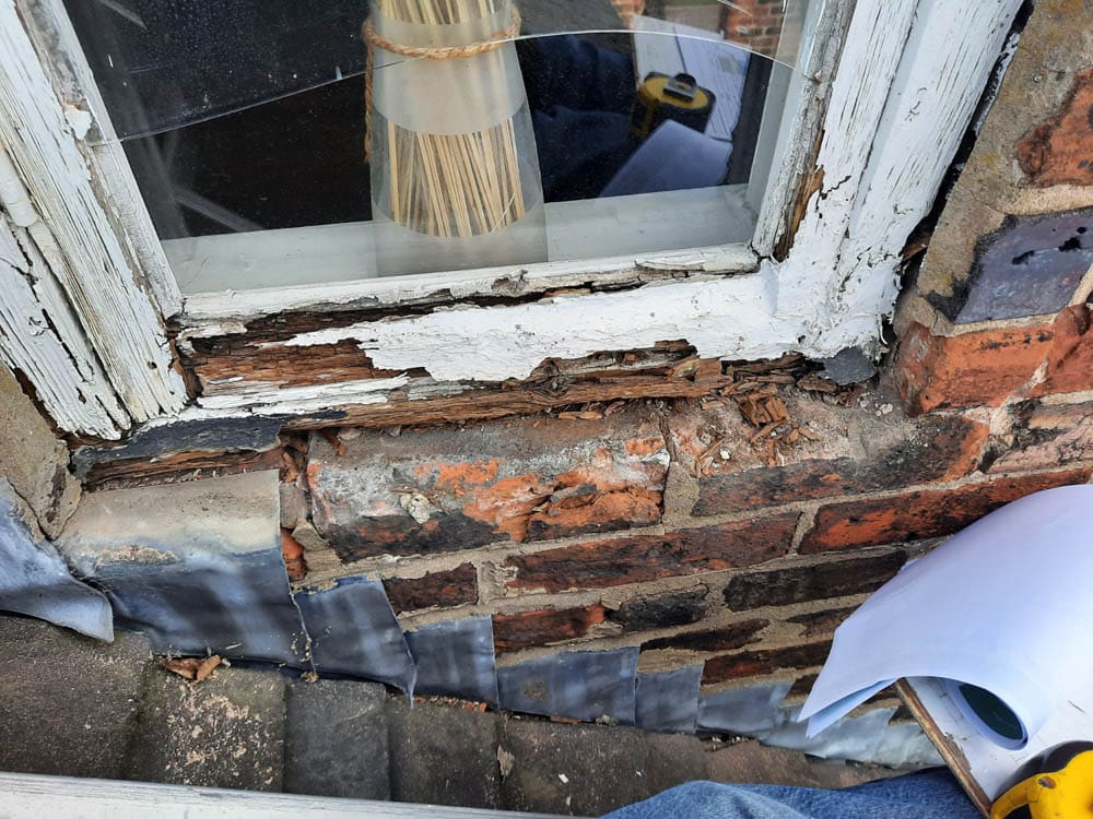 original timber sash window in a listed building showing the level of decay