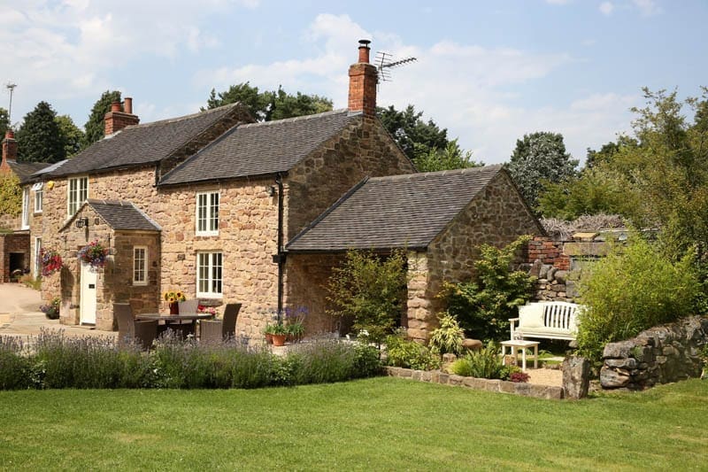 Long view of quarry cottage with new wooden windows and doors with vacuum glazing installed