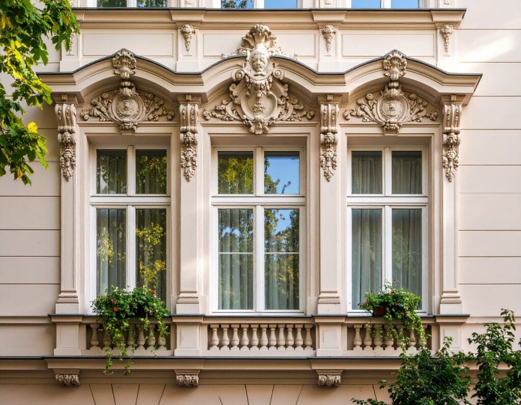 An elegant historic building with classic architectural details, showcasing a modern window installation with vacuum glazing in Poland