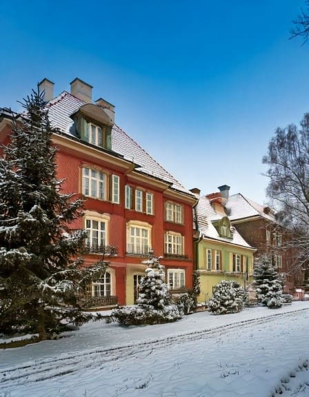 a view of a traditional townhouse in poland in the snow 41316-1