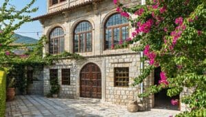 The image showcases a beautifully restored historic building in Turkey featuring traditional Ottoman architecture The facade is adorned with intricate wooden carvings and arched windows some of which have been expertly fitted with modern vacuum glazing