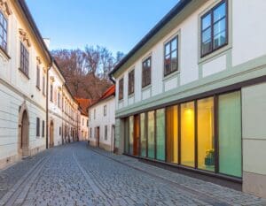 Contemporary home with ultra-slim vacuum glazed windows next to historic buildings in Bratislava, showing contrast between modern design and tradition